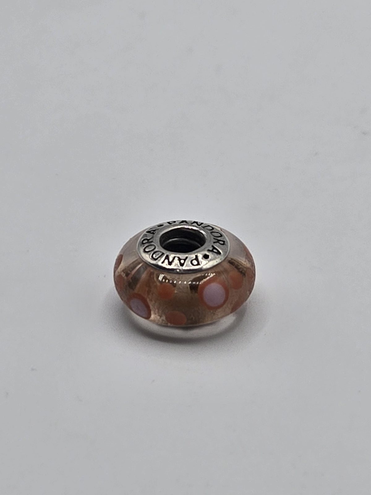 Pandora Peach and Coral Dot Murano Glass Charm on a plain light background