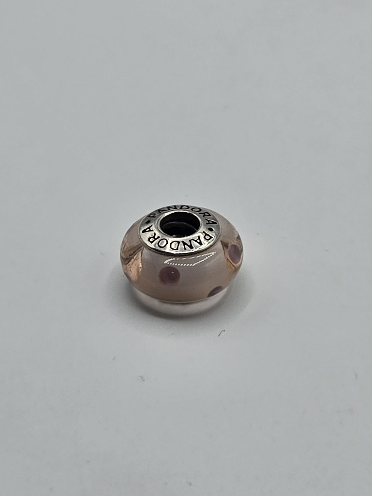 Pandora Peach and Plum Dot Murano Glass Charm on a plain light background