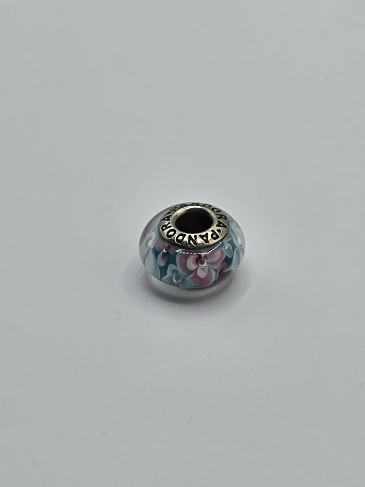 Pandora Pink and Blue Garden Flower Murano Glass Charm on a plain light background