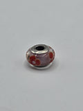 Pandora Pink and Red Poppy Murano Glass Charm on a plain light background