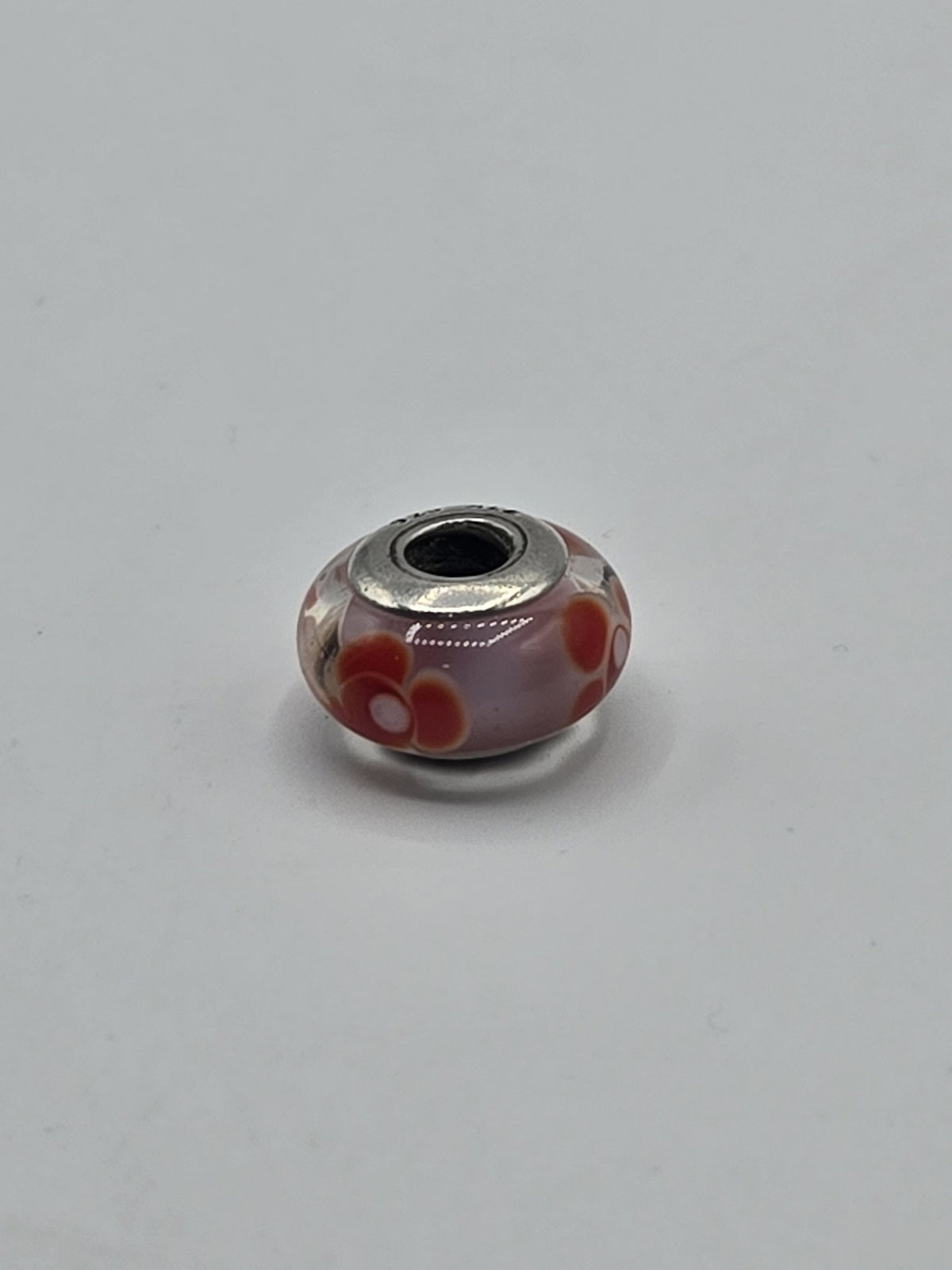 Pandora Pink and Red Poppy Murano Glass Charm on a plain light background