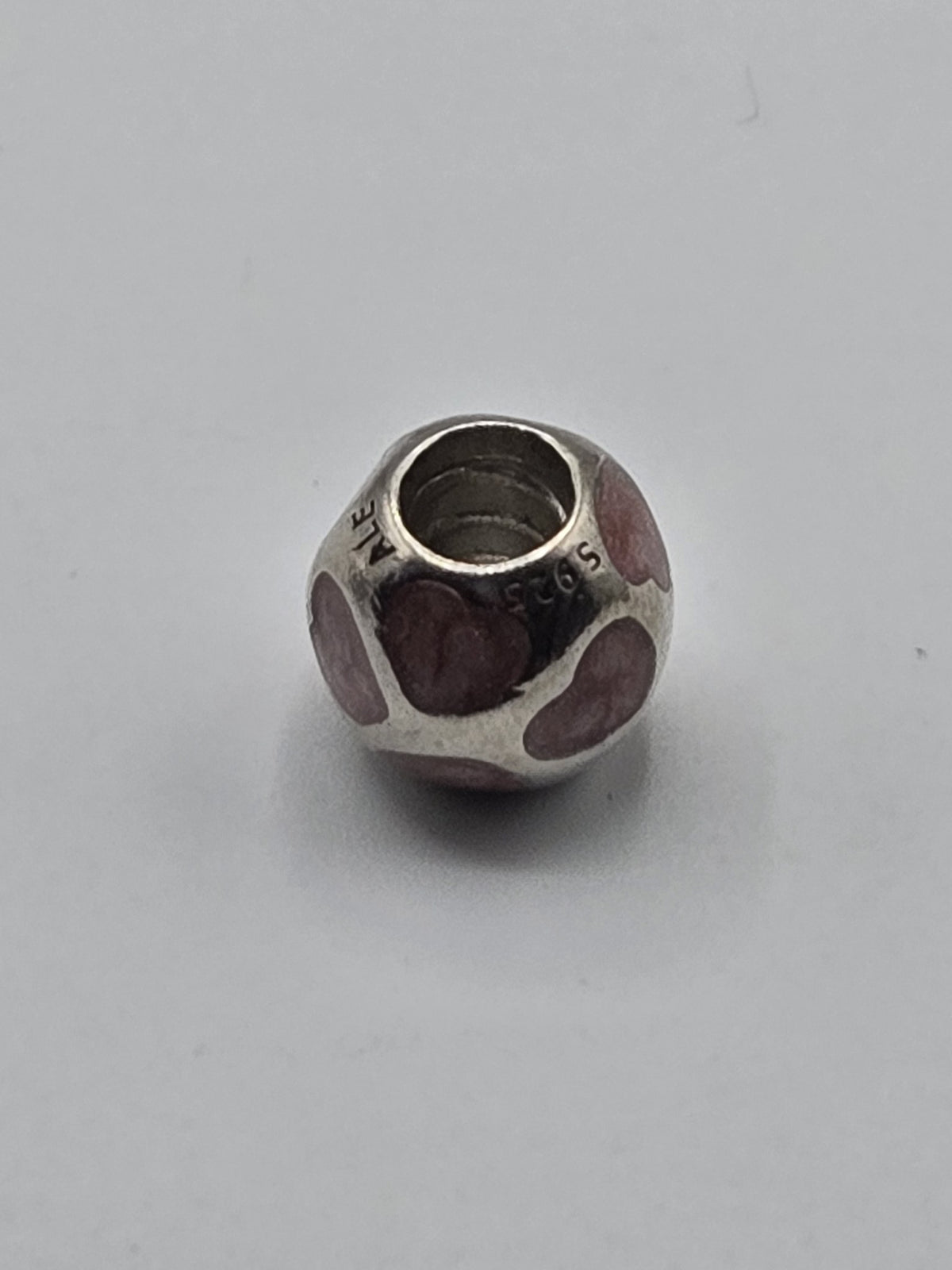 Pandora Pink Enamel Hearts Charm on a plain light background