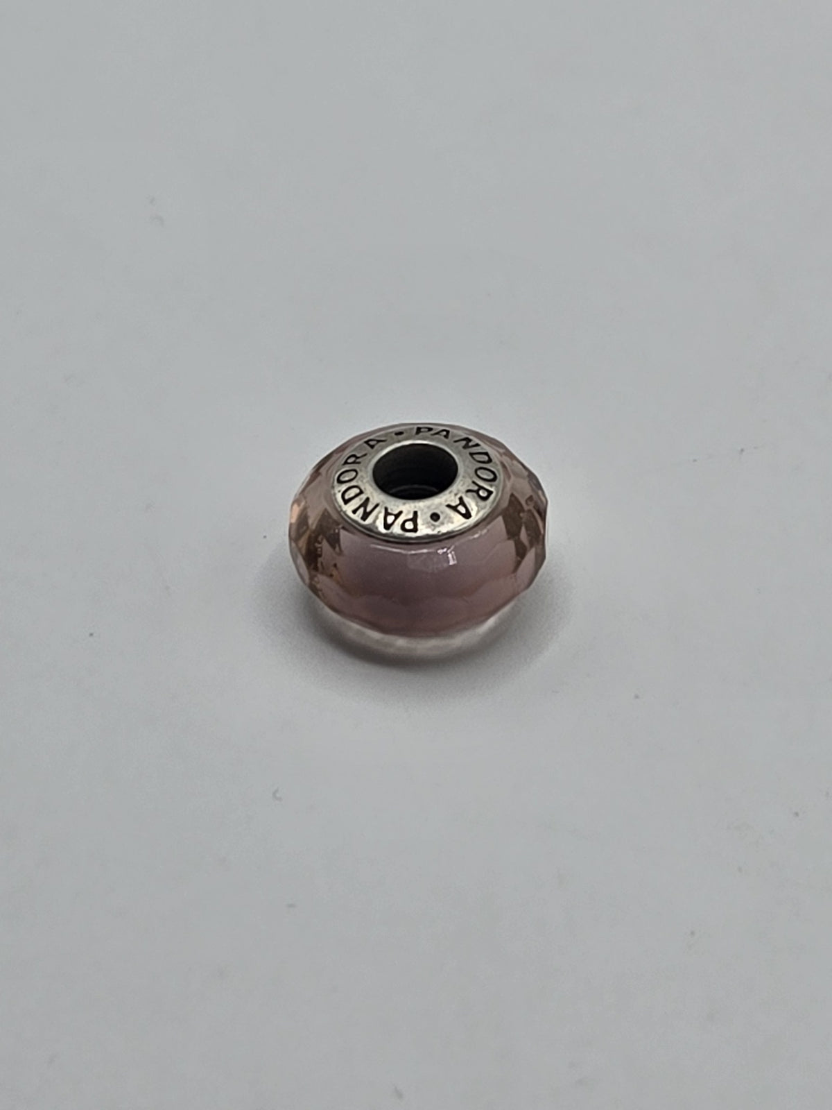 Pandora Pink Faceted Murano Glass Charm on a plain light background