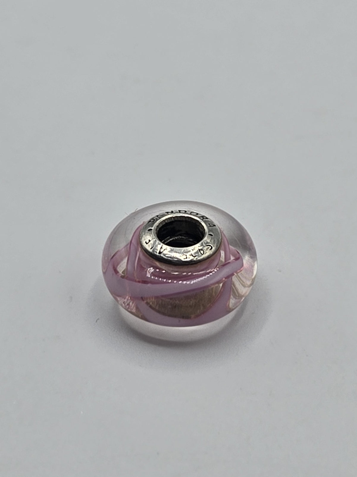 Pandora Pink Ribbon Swirl Murano Glass Charm on a plain light background
