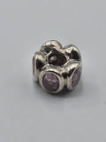 Pandora Pink Stone Flower Charm on a plain light background