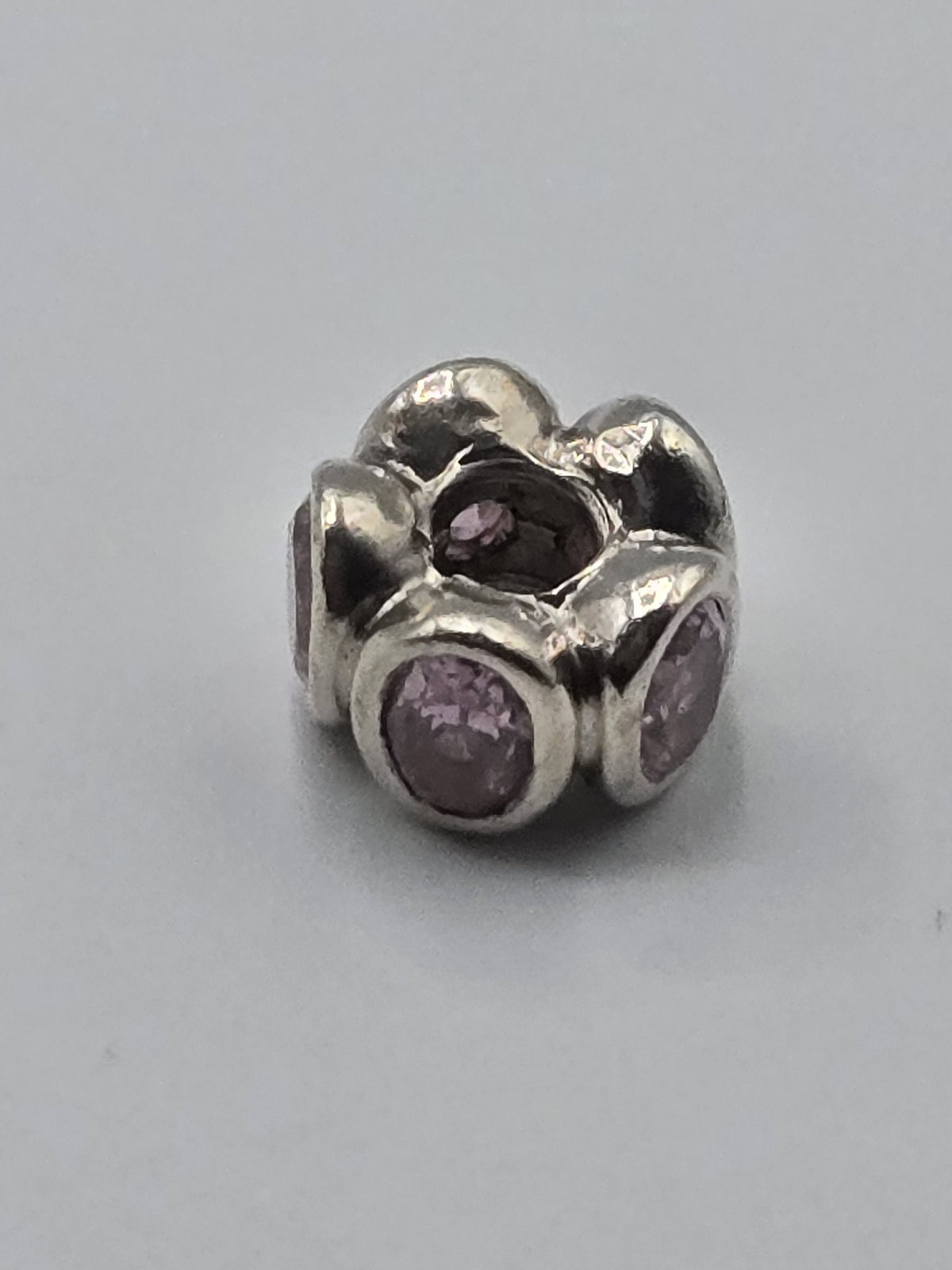 Pandora Pink Stone Flower Charm on a plain light background