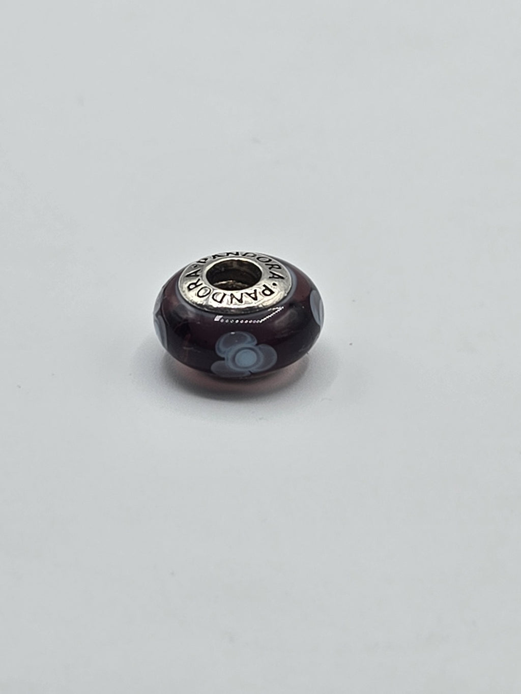 Pandora Plum and Pale Blue Flower Murano Glass Charm on a plain light background
