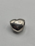 Pandora Polished Heart Charm on a plain light background