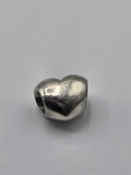 Pandora Polished Heart Charm on a plain light background
