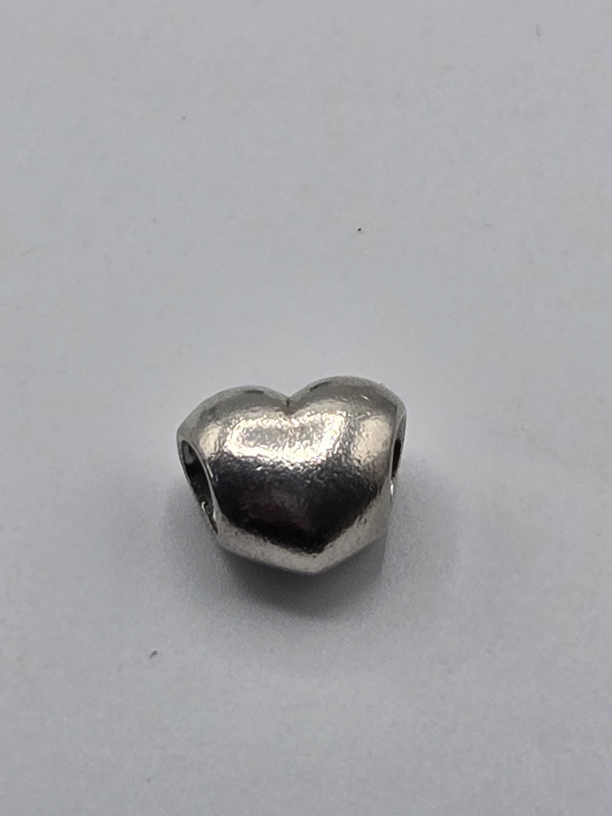 Pandora Polished Heart Charm on a plain light background