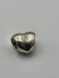 Pandora Polished Heart Charm on a plain light background