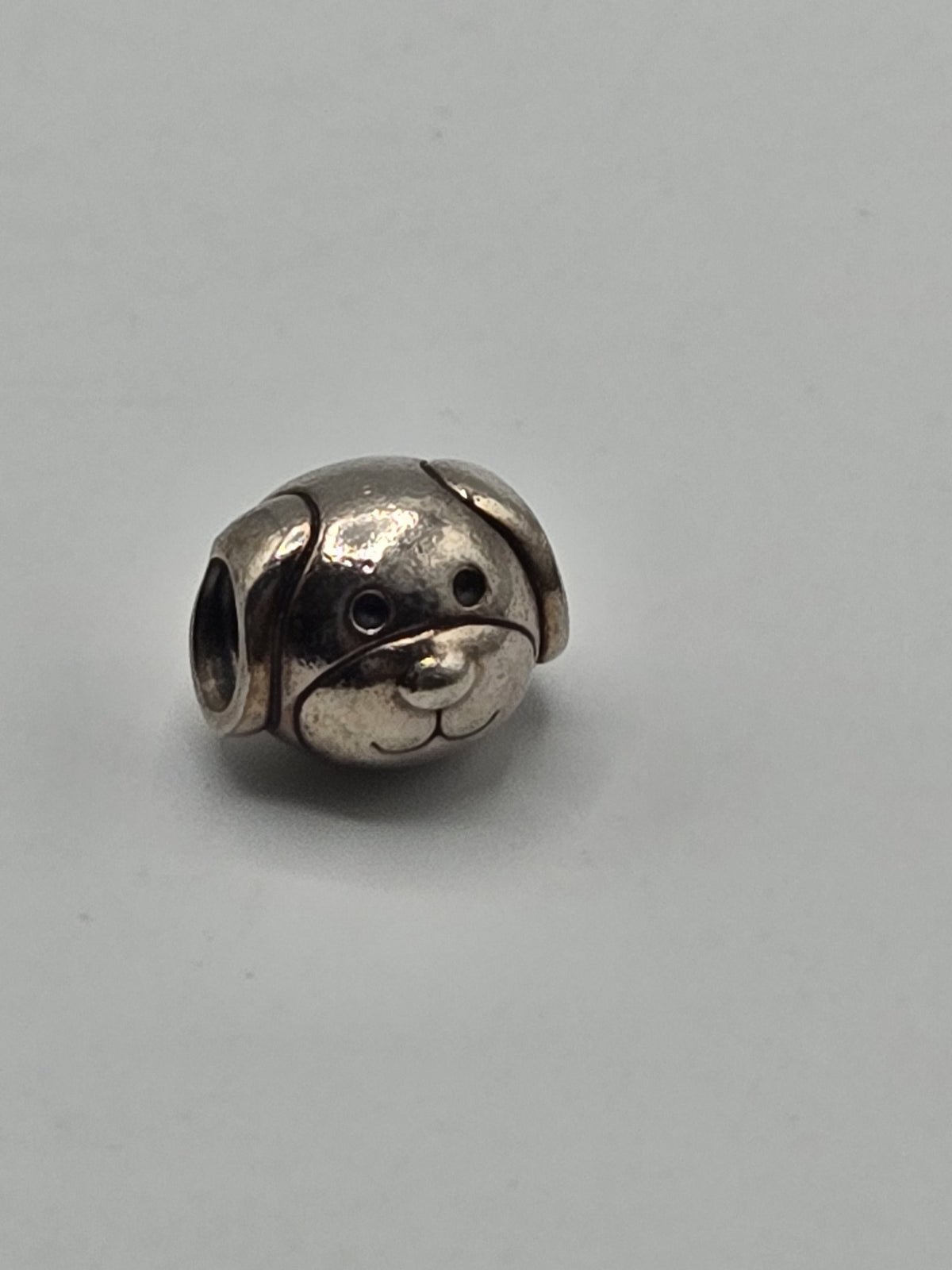 Pandora Puppy Face Charm on a plain light background