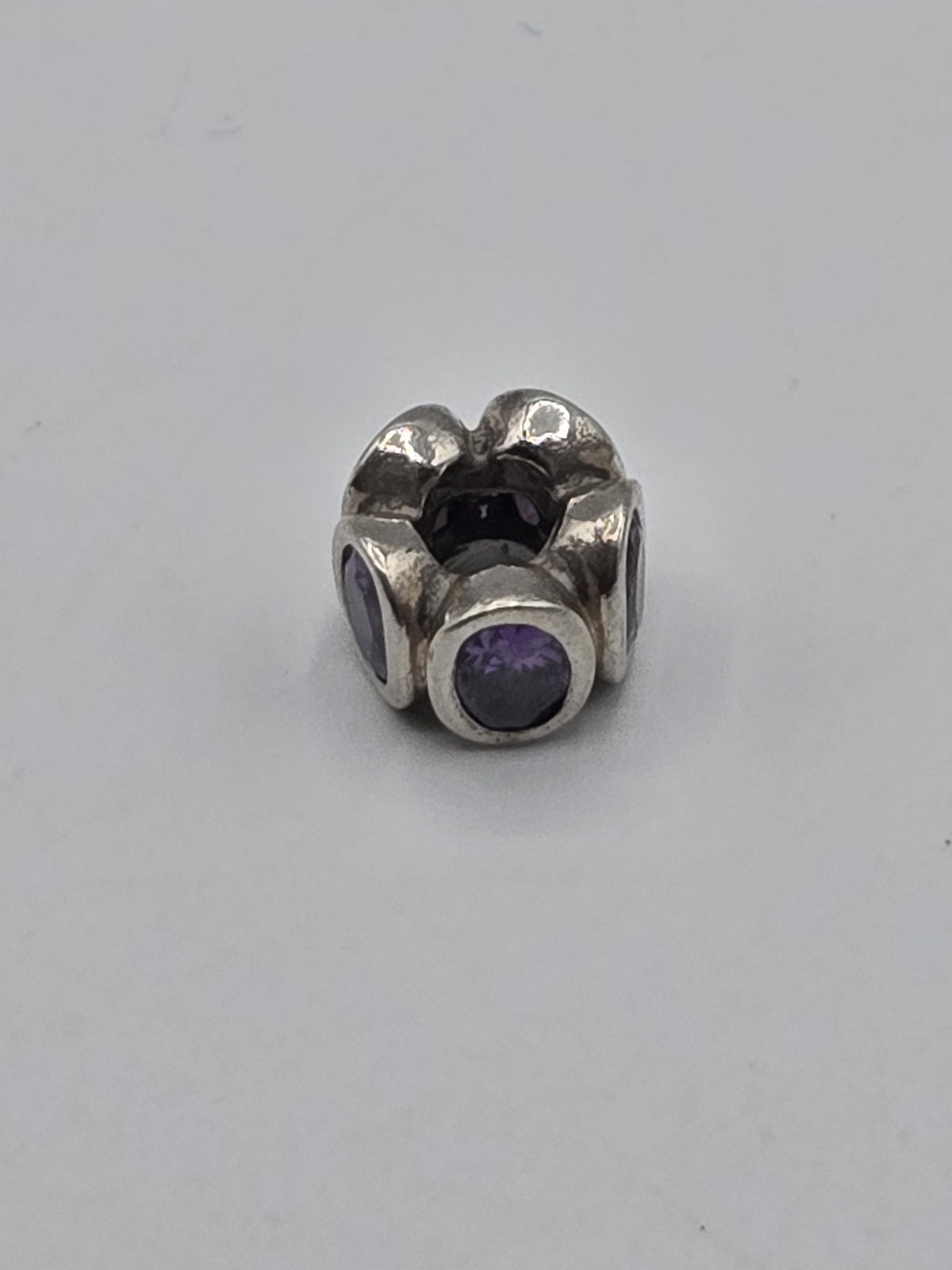 Pandora Purple Stone Flower Charm on a plain light background