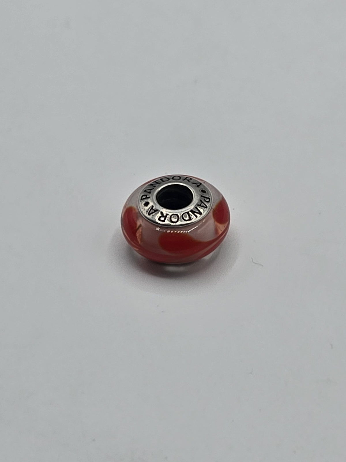 Pandora Red and Blush Heart Murano Glass Charm on a plain light background