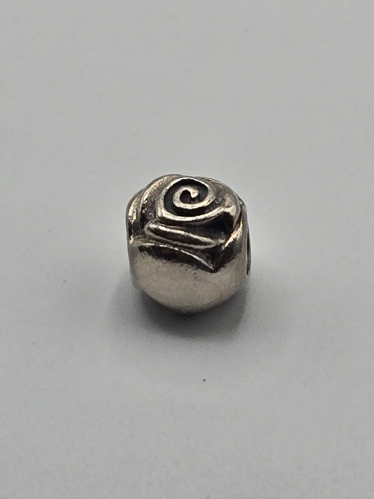 Pandora Rose Charm on a plain light background