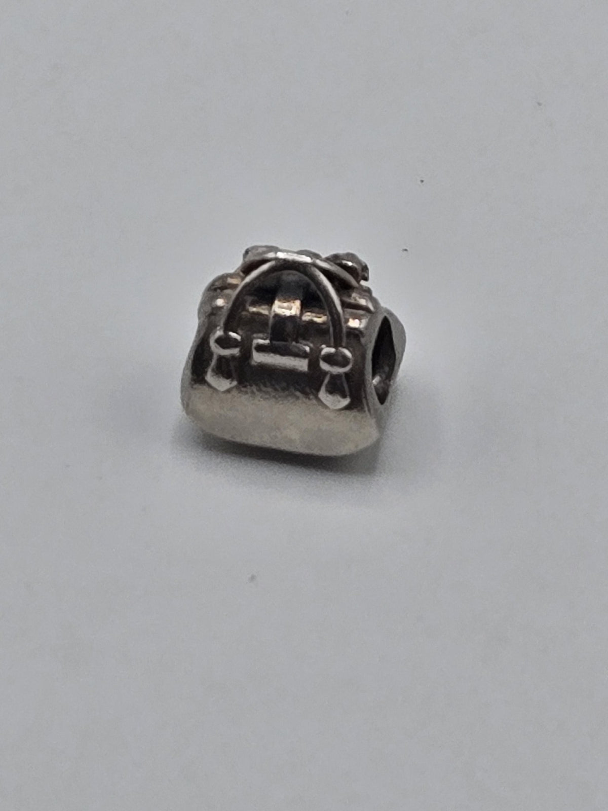 Pandora Silver Satchel Bag Charm on a plain light background