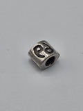 Pandora Silver Swirl Triangle Charm on a plain light background