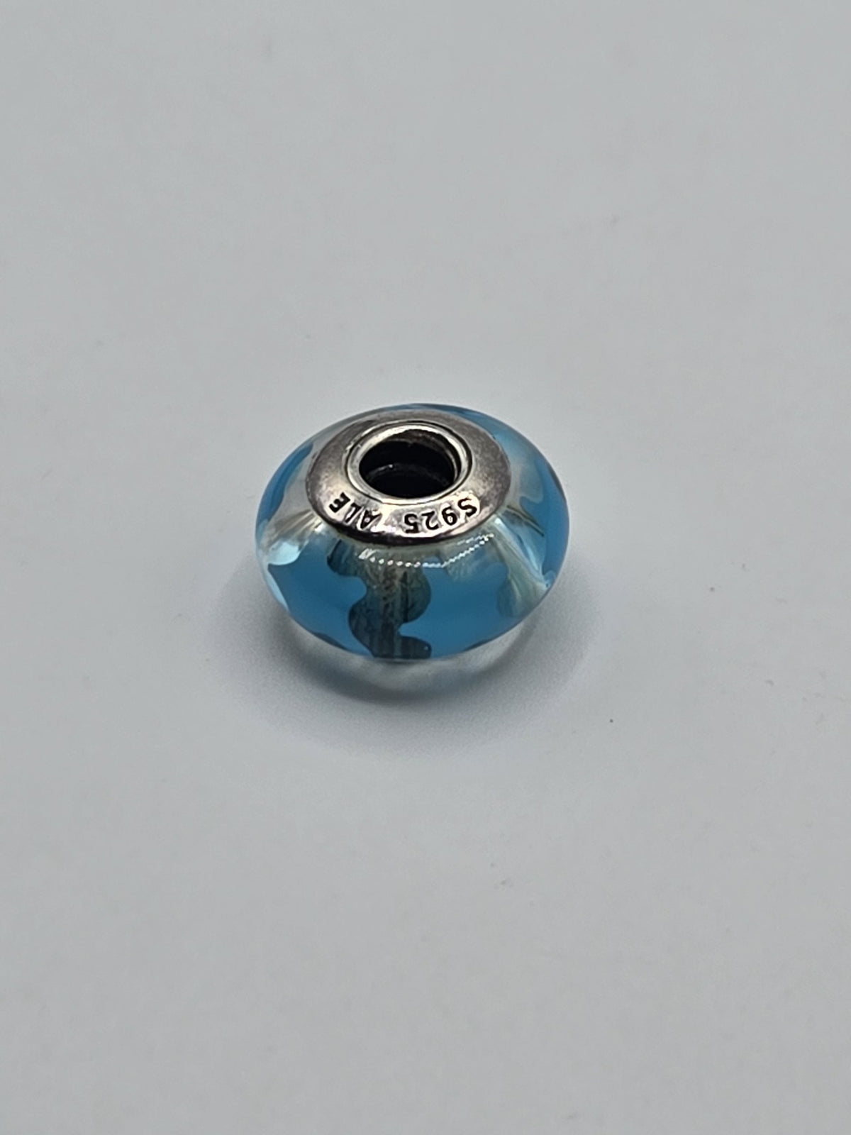 Pandora Sky Blue Wave Murano Glass Charm on a plain light background