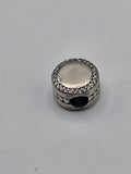 Pandora Sparkling Disc Charm with Hearts on a plain light background