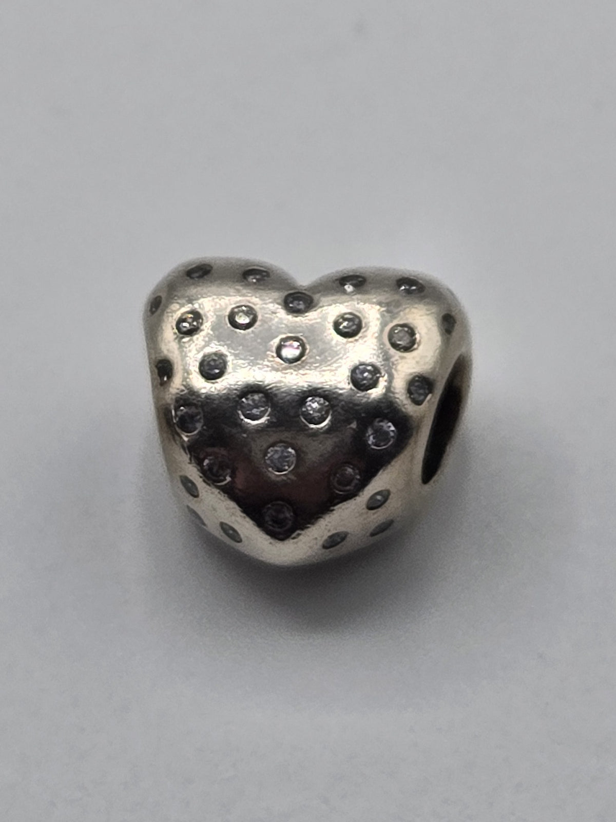 Pandora Sparkling Polka Dot Heart Charm on a plain light background