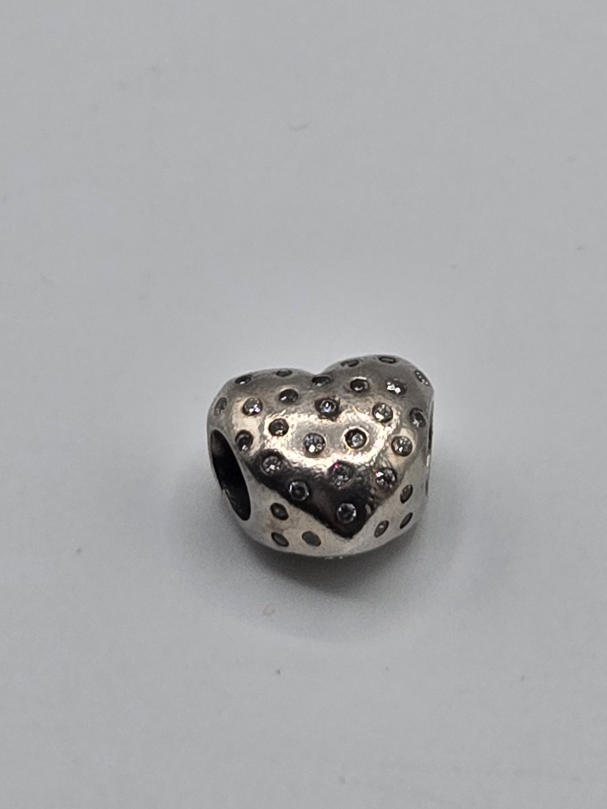 Pandora Spotted Heart Charm on a plain light background