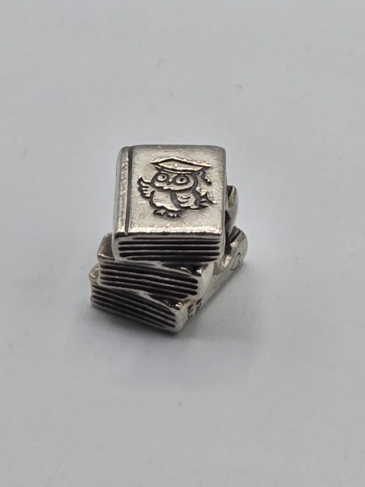 Pandora Study Books Charm on a plain light background