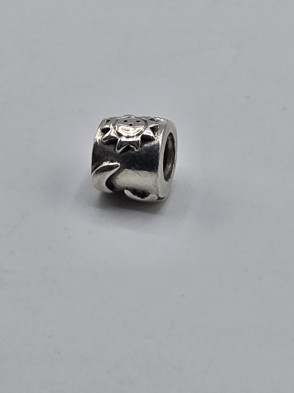 Pandora Sun and Moon Charm on a plain light background