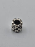 Pandora Swirl Charm with Lilac Stones on a plain light background