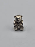 Pandora Teddy Bear Charm on a plain light background