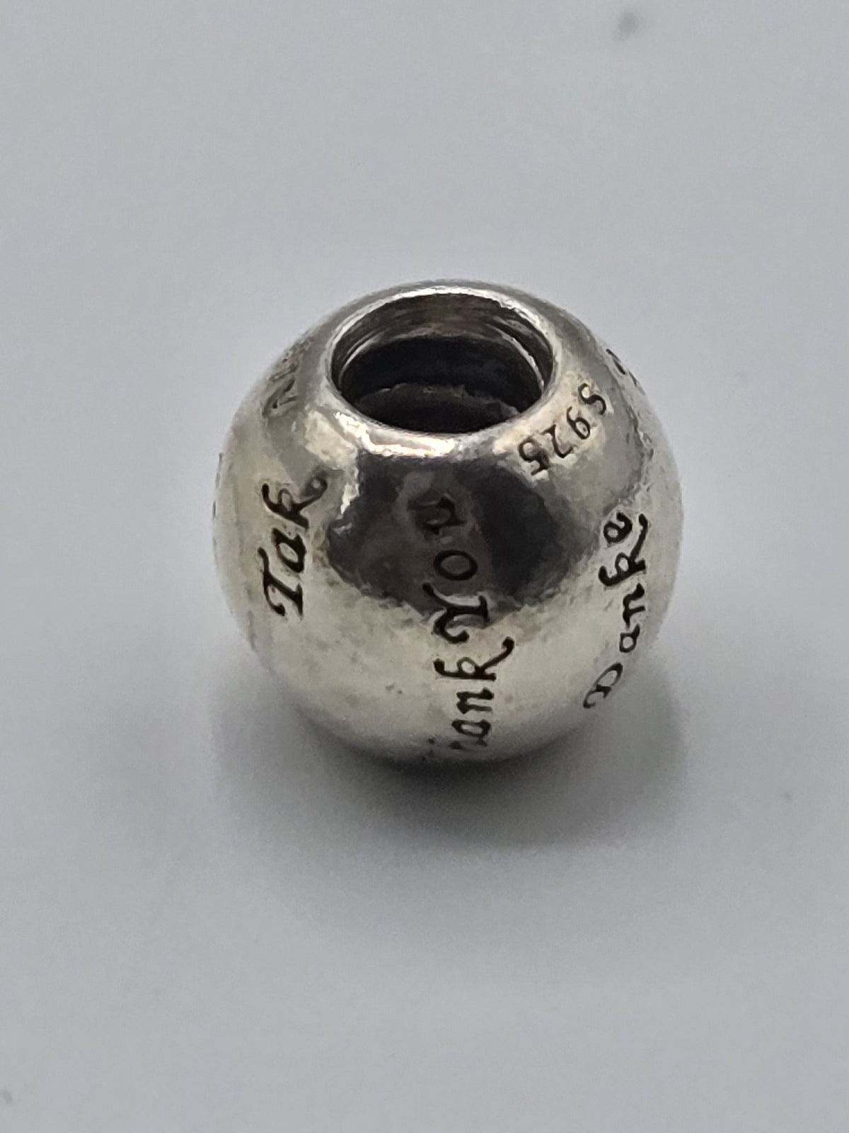 Pandora Thank You Charm on a plain light background