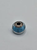Pandora Turquoise Petal Murano Glass Charm on a plain light background