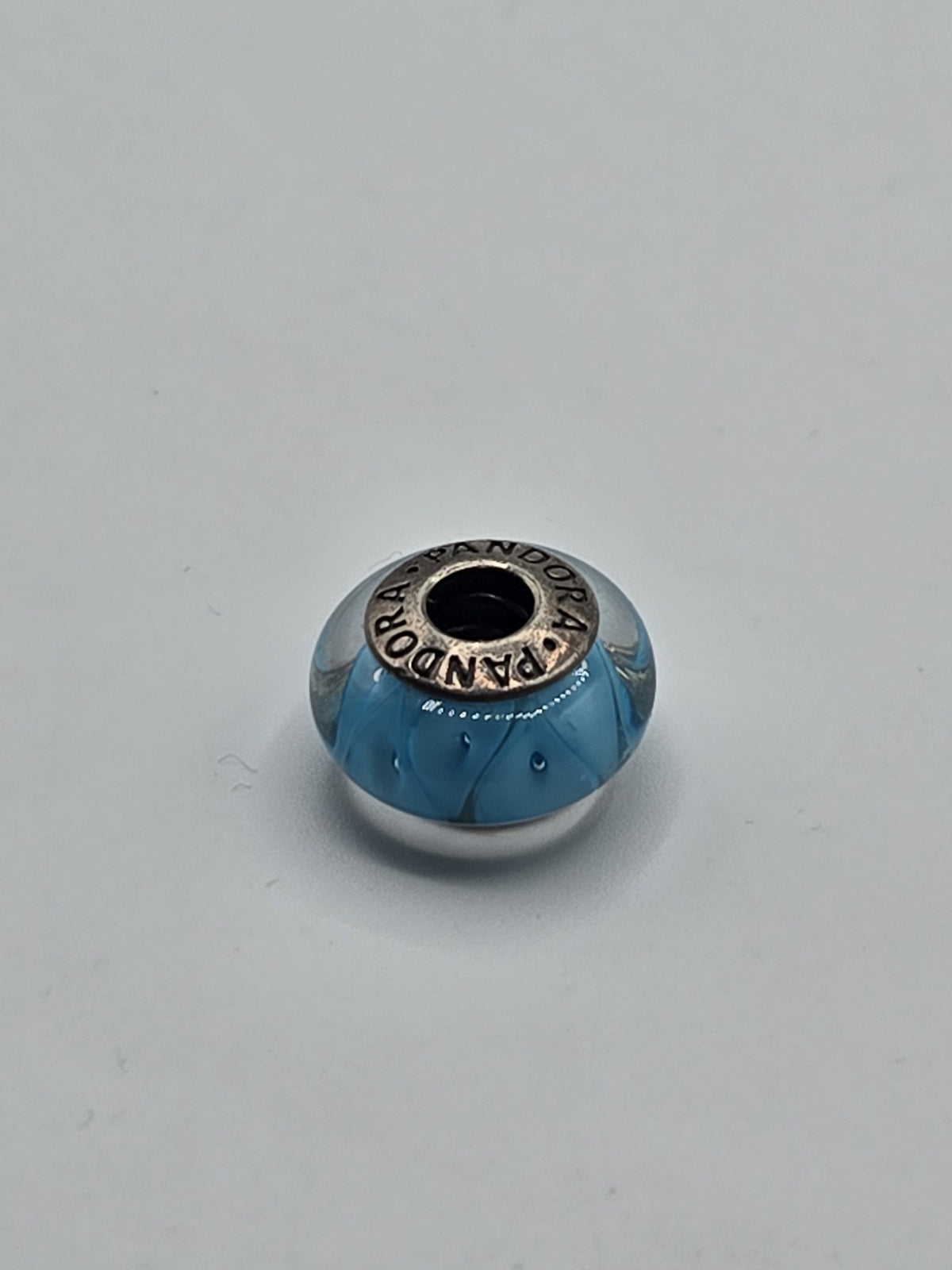Pandora Turquoise Petal Murano Glass Charm on a plain light background