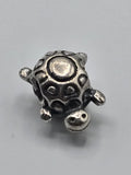 Pandora Turtle Charm on a plain light background