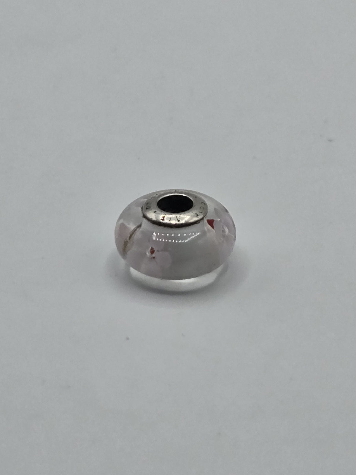 Pandora White Floral Murano Glass Charm with Red Accents on a plain light background