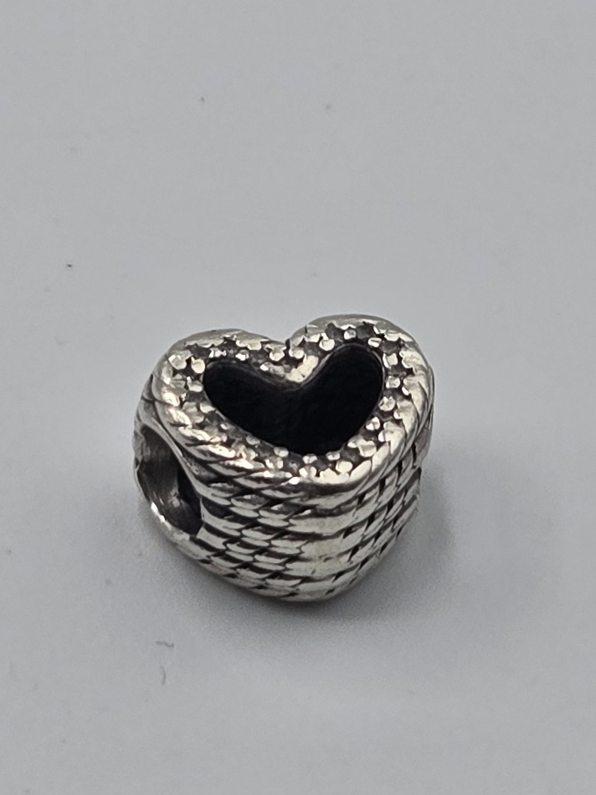Pandora Woven Heart Charm on a plain light background