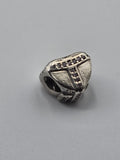 Pandora Wrapped Heart Charm with Purple Stones on a plain light background